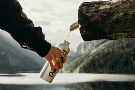 Person filling a reusable water bottle