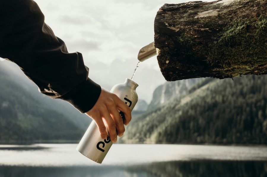 Person filling a reusable water bottle