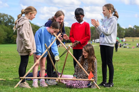 Group of six children taking part in an outdoor learning activity