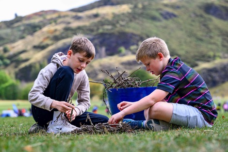 Two children taking part in an outdoor learning activity